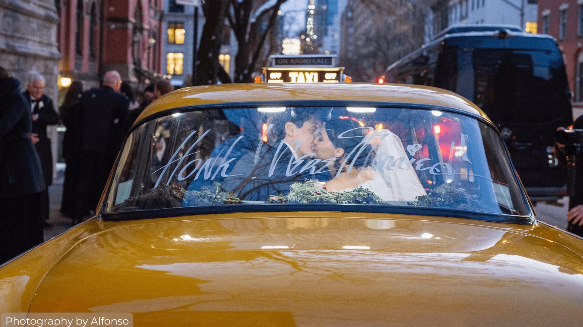 Bride and Groom kissing in a classic NYC Taxi Cab