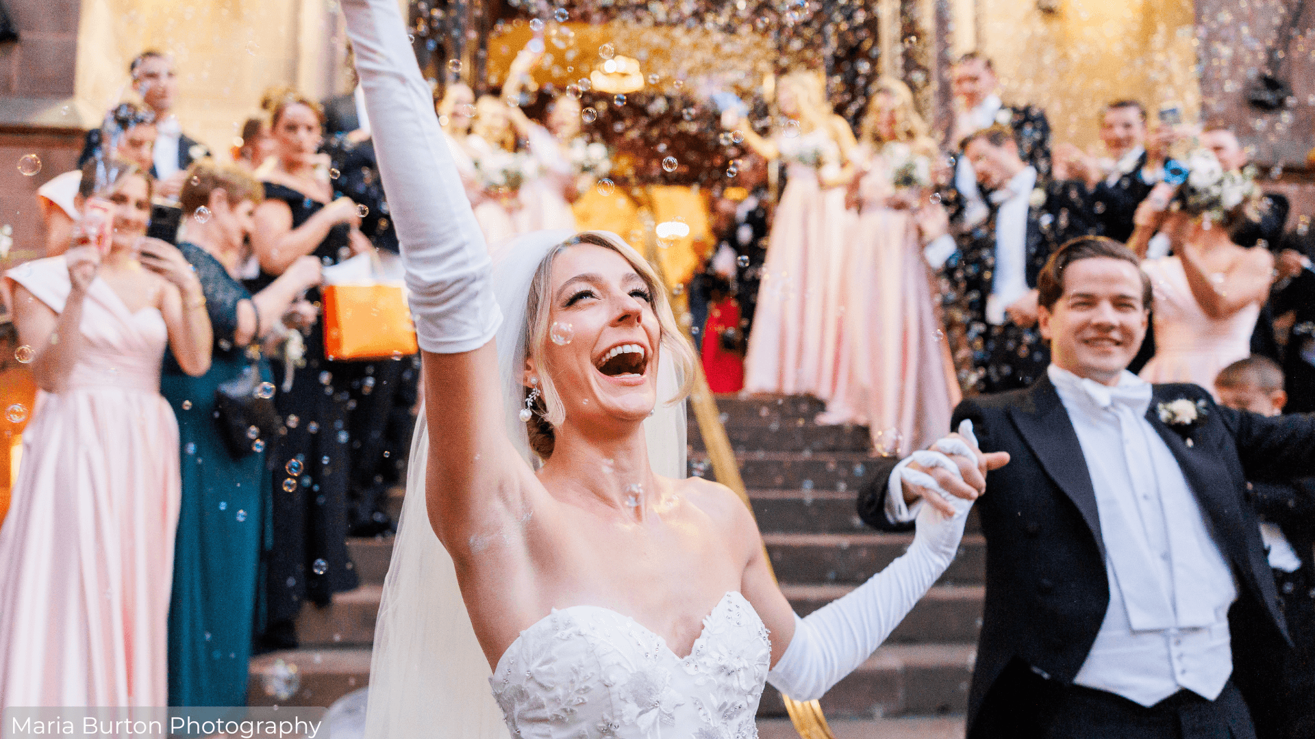 Bride and Groom exiting the ceremony with guests blowing bubbles